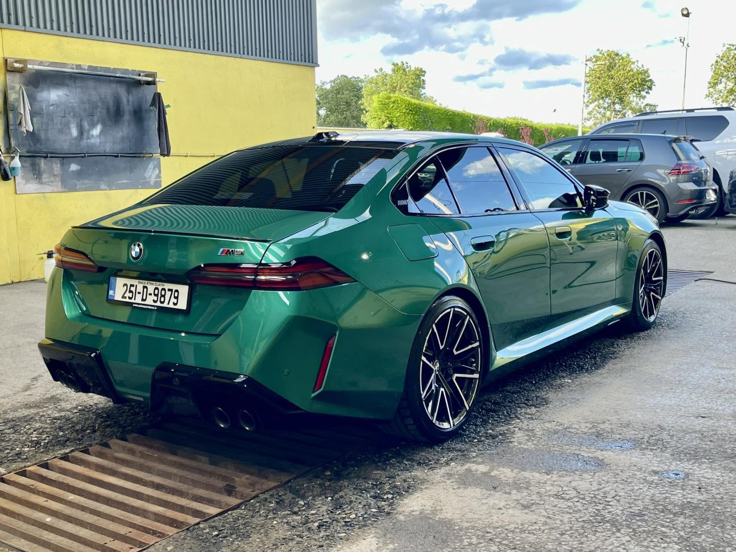 Green BMW M5 with a high-gloss finished exterior
