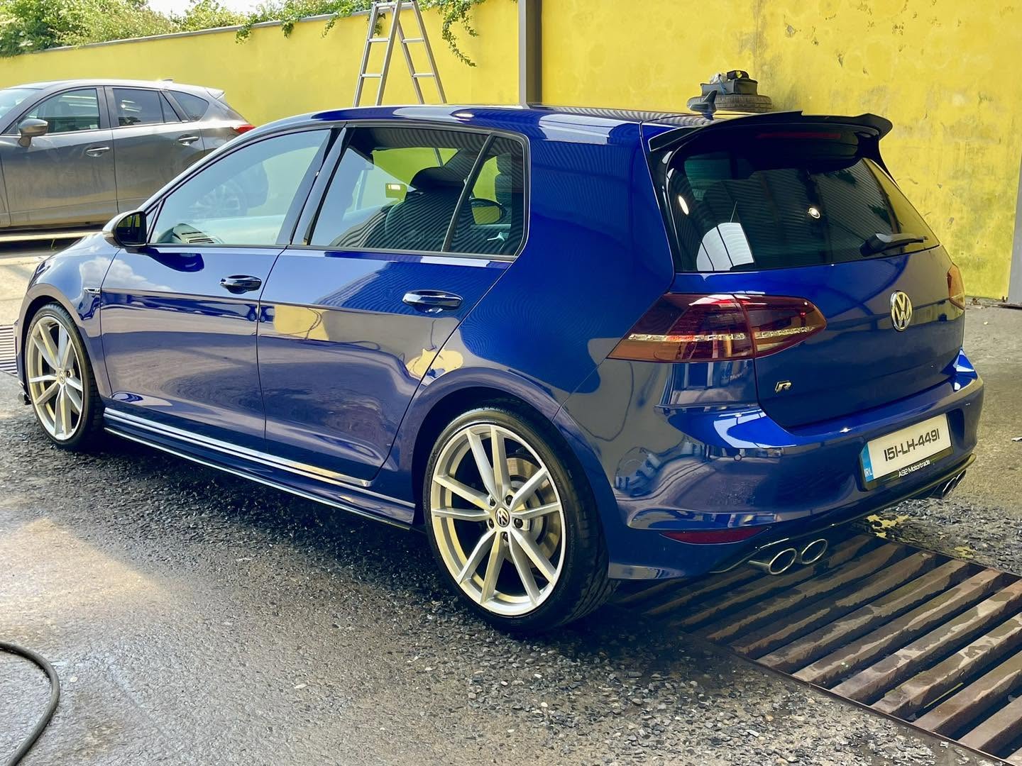 Blue Volkswagen Golf with glossy paintwork