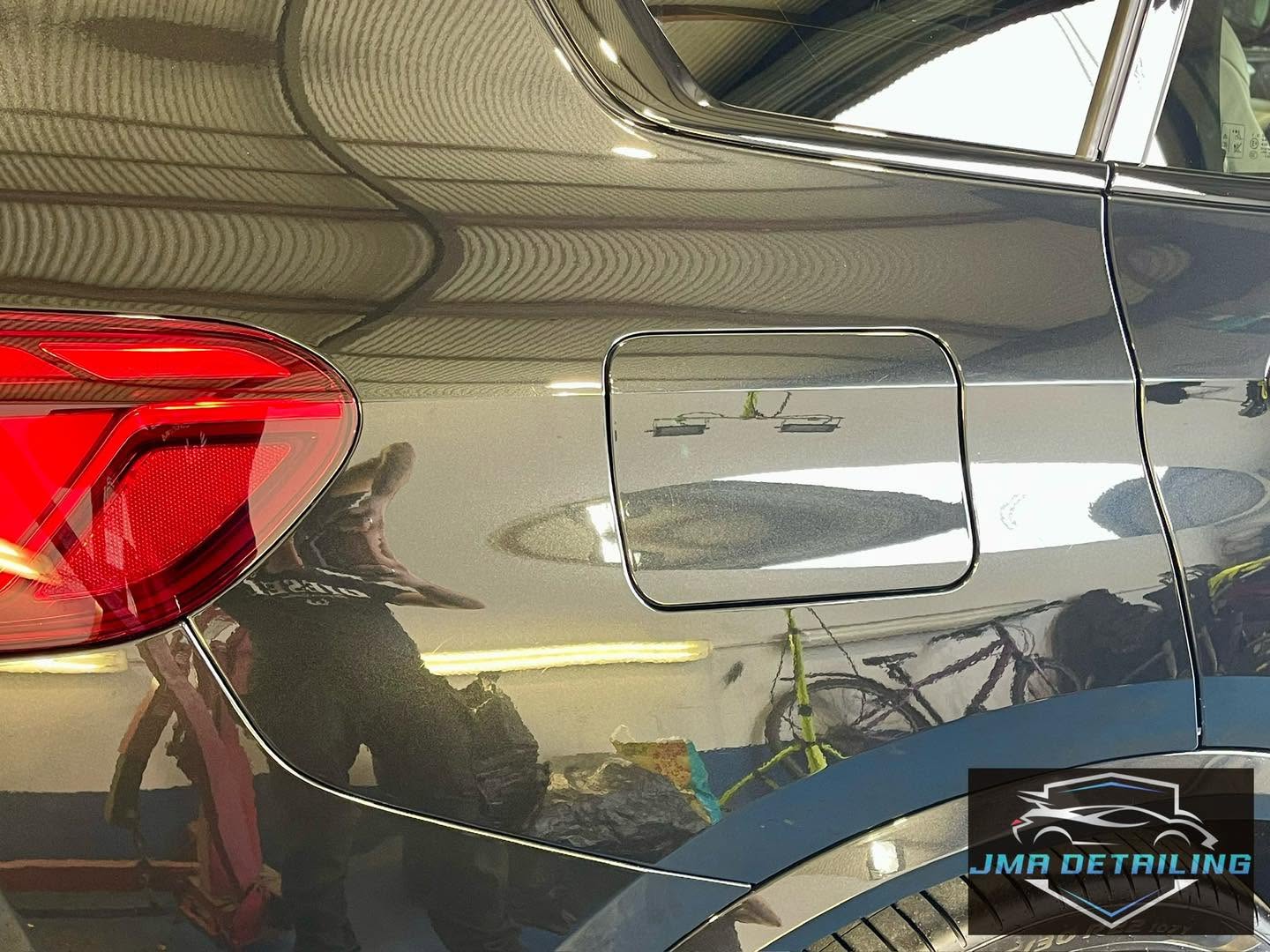 Corrected grey BMW rear quarter panel with a clear reflective finish